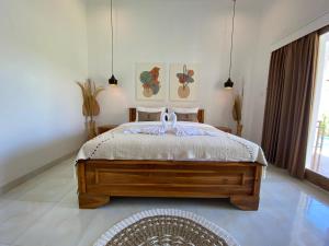 Postel nebo postele na pokoji v ubytování The Jangkar Canggu Guesthouse & Villa