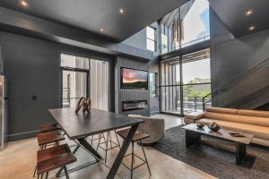 a living room with a table and a couch at Prolific Oasis Event Space HTX in Houston