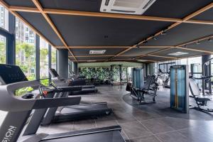 a gym with treadmills and chairs in a building at Cubic Botanical Chill Massage Chair 7km- MidValley in Kuala Lumpur