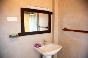 a bathroom with a sink and a mirror at Negombo Green Palace in Negombo +47 photos