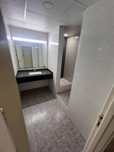 a bathroom with a sink and a mirror at Deira Family Rooms in Dubai