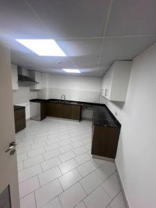 an empty room with a kitchen with a ceiling at Deira Family Rooms in Dubai