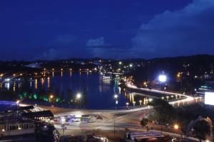 a city at night with a river and lights at Thanh Do Hotel in Da Lat