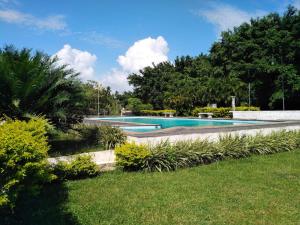 two swimming pools in a yard with trees at Green Island Nature lodge and Villa in Kammala South