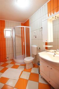 a bathroom with a toilet and a shower and a sink at Apartments Baron in Sveti Stefan +133 photos