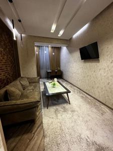 a living room with a couch and a table at LOTUS APARTMENTS in Dushanbe