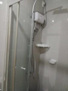 a shower in a bathroom with a glass shower stall at Grass residence tower3 30th Floor in Manila