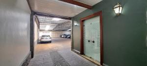 a garage with a door and a car parked in it at Hotel Orleans in Petrópolis