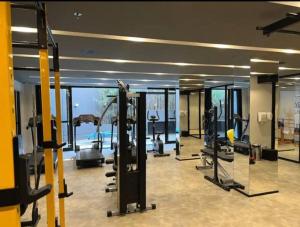 a gym with treadmills and machines in a building at Studio fácil acesso a paulista in Sao Paulo