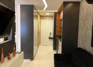 a room with a hallway with a door and a kitchen at Studio fácil acesso a paulista in Sao Paulo +13 photos