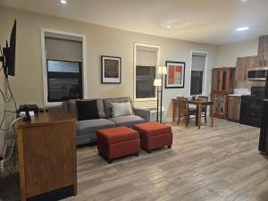 a living room with a couch and a table at Spacious 2 Bedroom Loft Apt #7 in Gatineau
