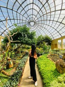 a woman is standing in a greenhouse at Bundala Resort in Tissamaharama