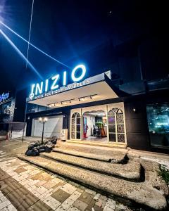 a building with a sign on top of it at Inizio Hotel Boutique Laureles in Medellín