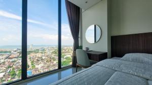a bedroom with a bed and a desk with a mirror at Palam Mansion at Meisterstadt Pollux Habibie Apartment in Batam Center +136 photos