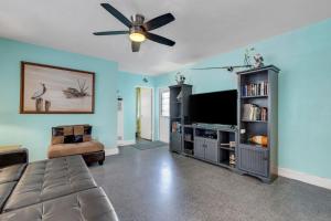 uma sala de estar com um sofá e uma televisão de ecrã plano em Captain's Quarters - Weekly Rental apts em Clearwater Beach