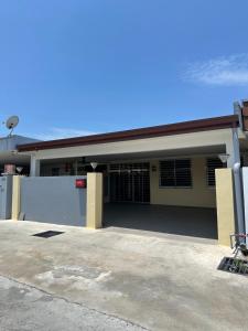 a building with a parking lot in front of it at Penampang Delima House in Kota Kinabalu