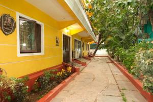 an empty hallway of a yellow building with plants at 2 BHK beach goan villa with pool calangute in Calangute