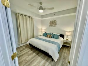 a bedroom with a bed with blue pillows at Balcony King Suite - Lake & Pool view in Orlando +180 photos
