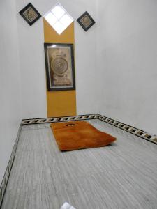 a room with a bed with a rug on it at Vila Bumi Madinah Dau-Malang in Dau