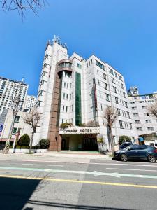 a car parked in front of a large building at Prada motel in Geoje 