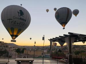 a group of hot air balloons flying over a city at Alaturca House in Göreme