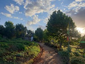a dirt road with a flag on a fence at HOLLYBROOKE Campsites in Skeerpoort