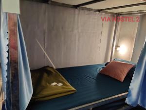 a bed in a tent with a pillow on it at Via Pakse Hostel & Cafe in Pakse