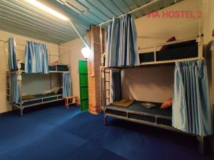 two bunk beds in a room with a room with at Via Pakse Hostel & Cafe in Pakse