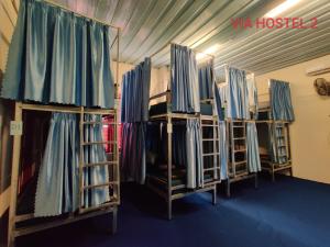a row of bunk beds in a room at Via Pakse Hostel & Cafe in Pakse