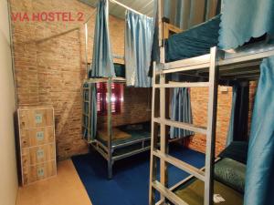 a room with several bunk beds in a building at Via Pakse Hostel & Cafe in Pakse +6 photos