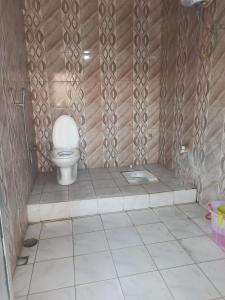 a bathroom with a toilet in a room at Ashu Homestay in Ayodhya