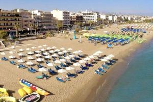 an aerial view of a beach with chairs and umbrellas at The Zen Apartment City Of Rethymnon in Rethymno Town
