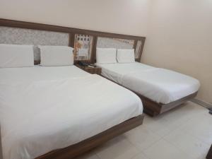 Tempat tidur dalam kamar di Hotel Dada intdxin