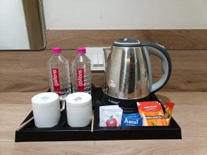 a black tray with a tea kettle and two cups at Hotel Kant by GoHotels - Best Hotel Near Shree Dwarkadhish Temple in Dwarka