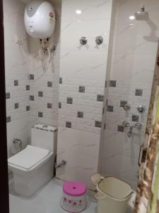 a small bathroom with a toilet and a shower at Hotel Dada intdxin in New Delhi