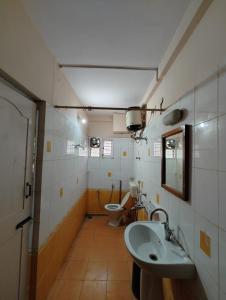 a bathroom with a sink and a toilet at Varal Mane in Bangalore