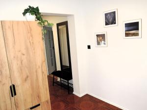a room with a door and a plant on the wall at Large holiday apartment with a garden in Stepnica in Stepnica