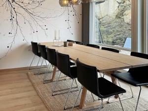 a dining room with a wooden table and chairs at 10 person holiday home in Lindesnes in Spangereid