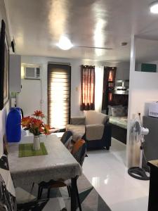 a living room with a table and a couch at The Escape Pad 3 in Manila