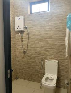 a bathroom with a toilet and a shower at A 7 Villa in Quartier Militaire