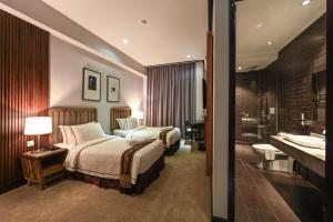 Postel nebo postele na pokoji v ubytování 1825 Gallery Hotel