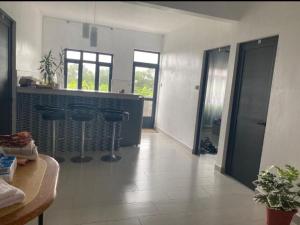 a kitchen with a counter and stools in a room at A 7 Villa in Quartier Militaire