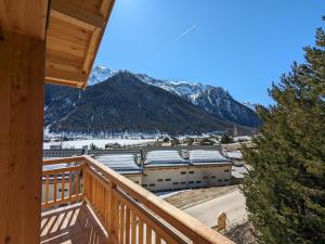 a view from the balcony of a resort with snow covered mountains at chalet panoramique in Ceillac