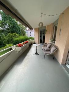 a living room with a couch and a table on a balcony at Sempachersee Luzern in Neuenkirch