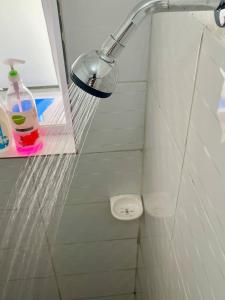 a shower with a shower head in a bathroom at Ample home 2 bedroom apartment in Mombasa