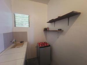 a small kitchen with a sink and a window at Sea Esta Beach House in Boljoon