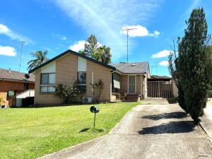 a house with a tree in the front yard at Penrith Relaxing Beauty 3BR Entire House Sleep 8 in Penrith