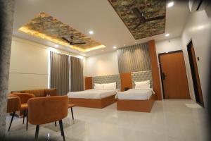 Hotel Pride Of Chittor客房内的一张或多张床位