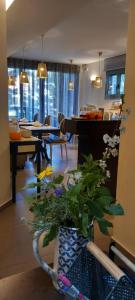 a living room with a vase with flowers in it at Aerinon Guesthouse in Nafplio