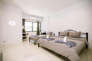 a bedroom with two beds with towels on them at LD1.House Private Room,Thapae Gate, Chiang Mai Old city in Chiang Mai